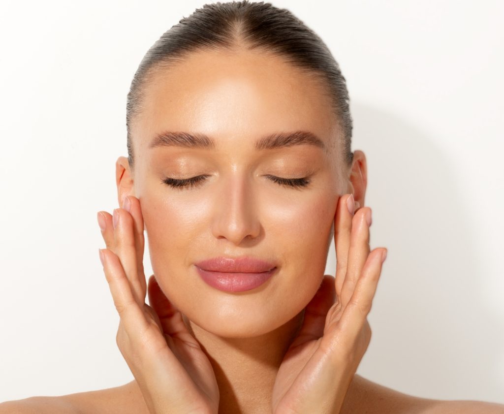 Woman Smiling feeling her clear skin