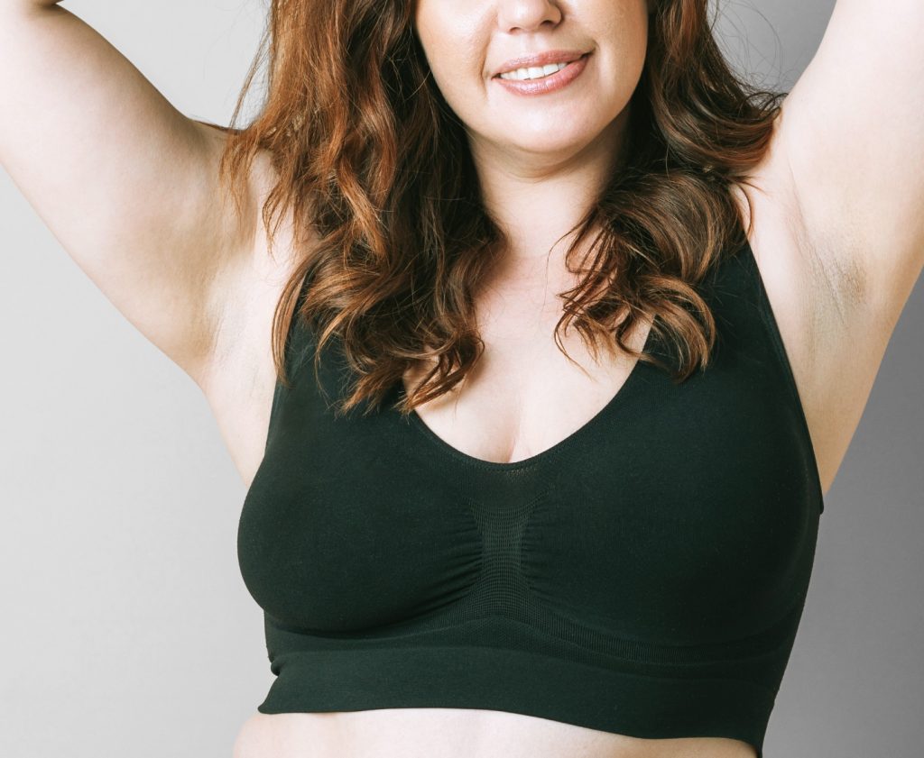 woman in black sports bra smiling